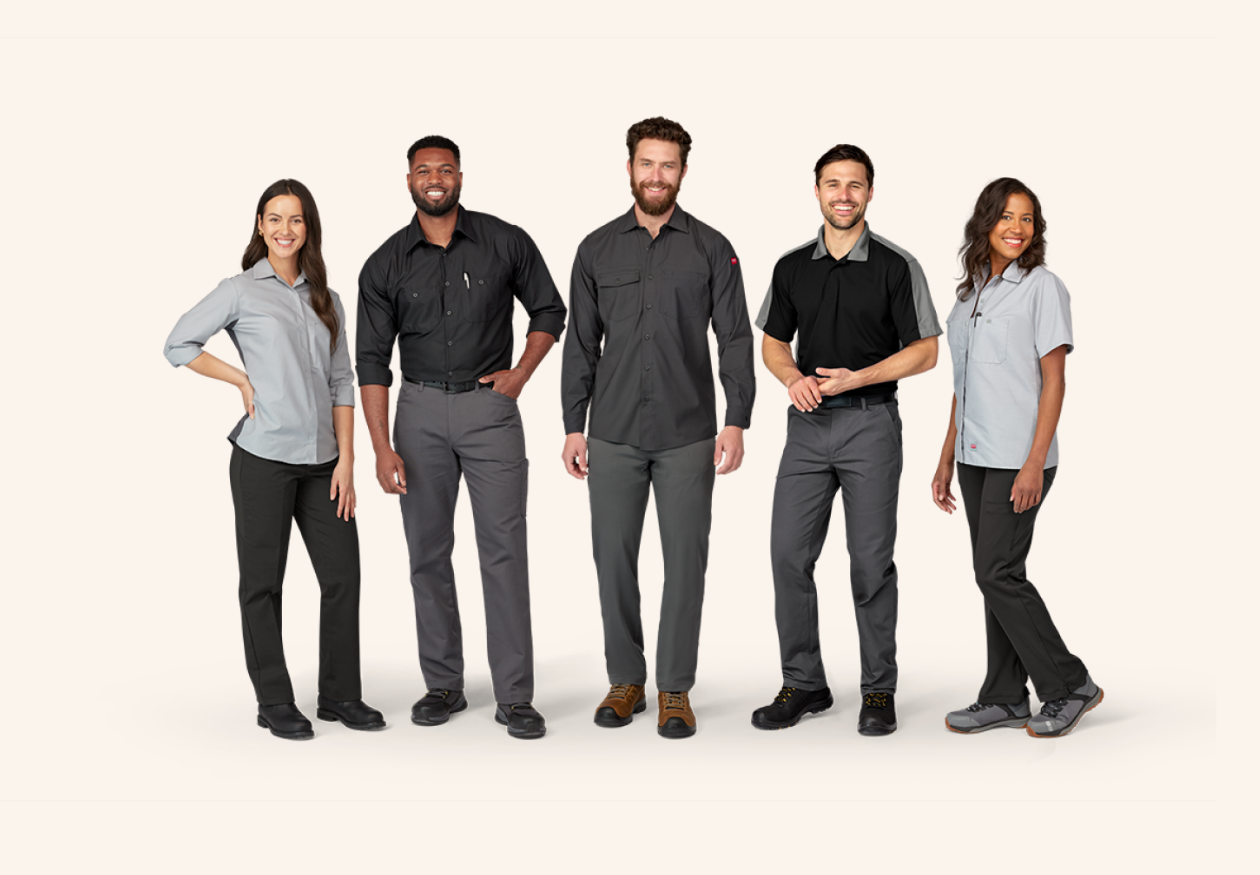 a group of happy workers standing together wearing Red Kap workwear